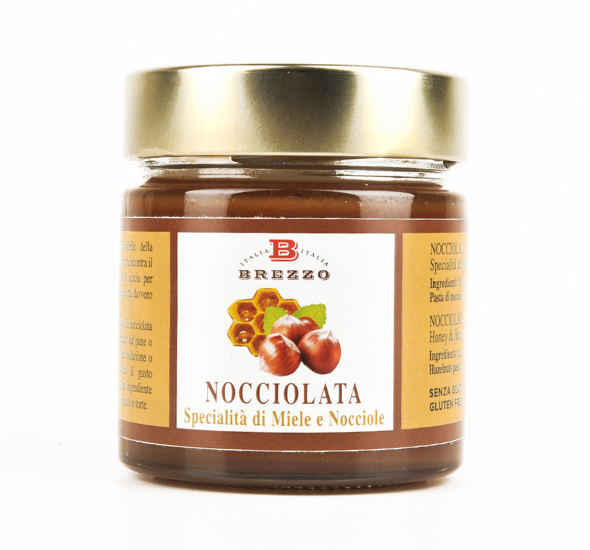 Jar of Nocciolata chocolate-hazelnut spread with a gold lid, label featuring hazelnuts and a beehive motif.