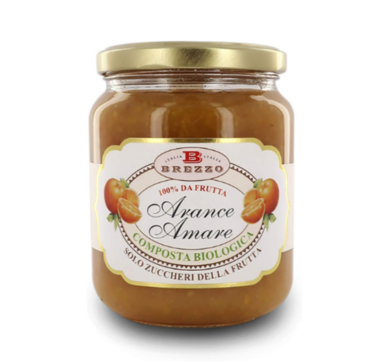 Jar of Brezzo orange marmalade labeled 'Arance Amare' with 100% da frutta, Biologica, in a glass jar with a gold lid.