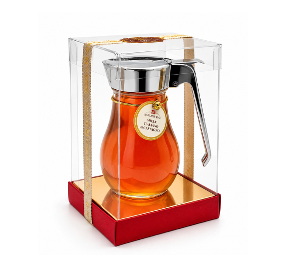 Gift-boxed glass honey decanter filled with amber chestnut honey, featuring a metal spout and gold tag.