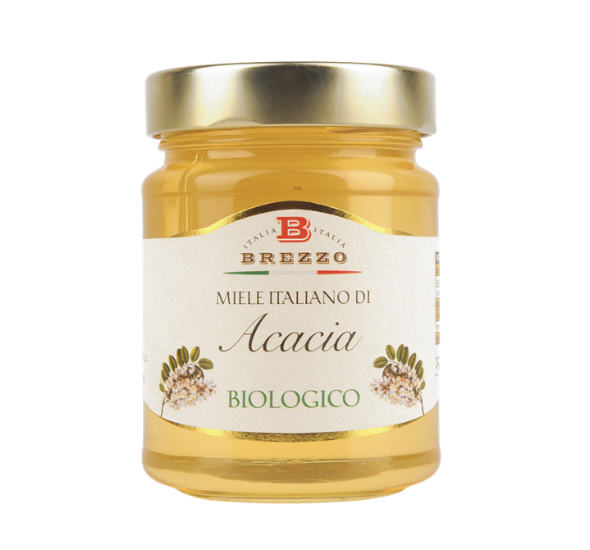 Jar of organic Acacia honey with a gold lid and a beige label reading Miele Italiano di Acacia Biologico (Brezzo brand)